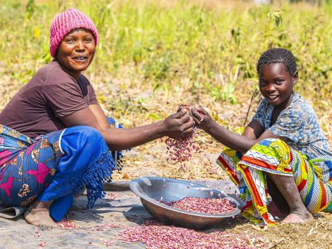 A mother with her daughet rejoiced by their harvest